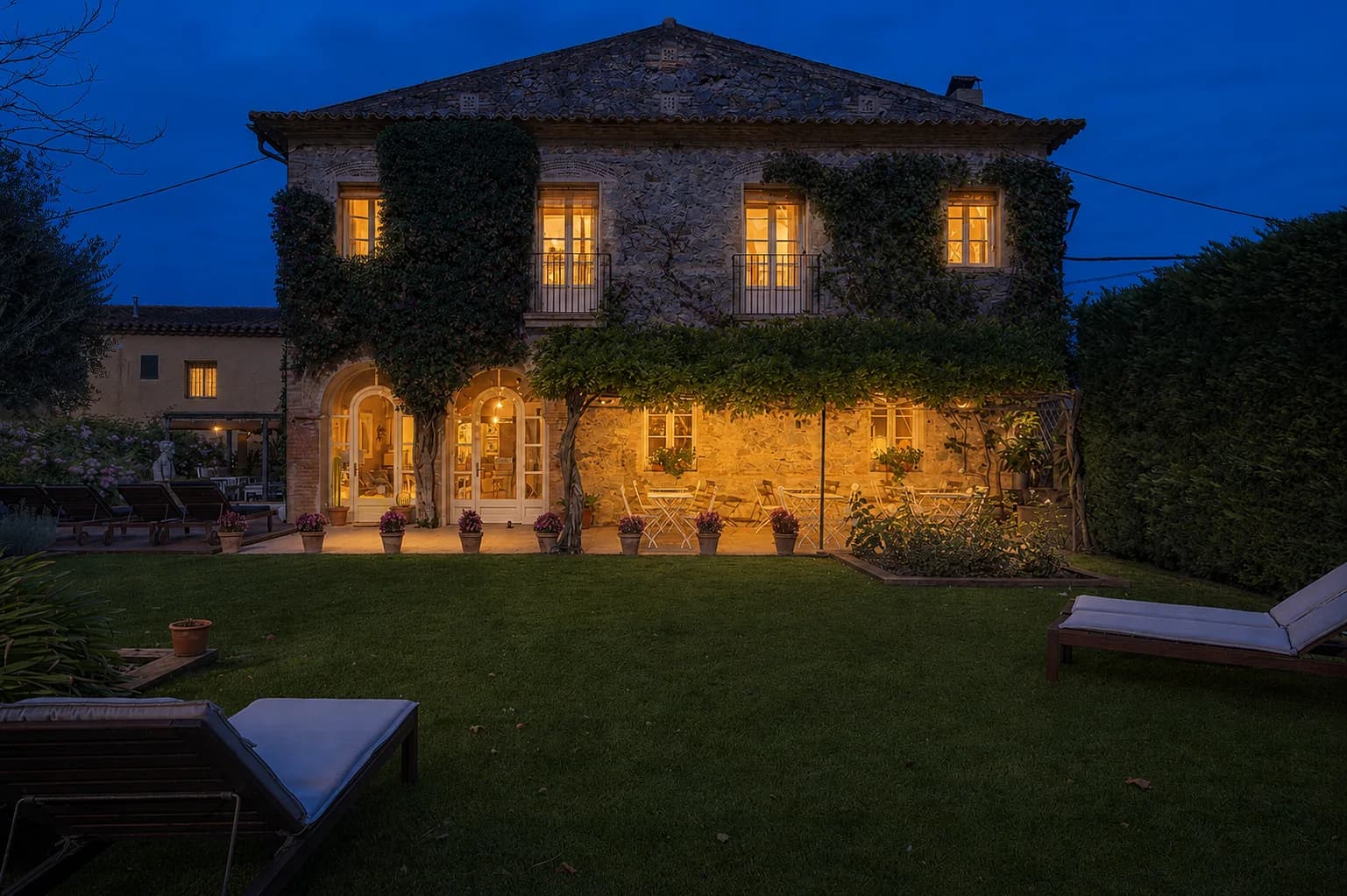 Hort de Sant Cebrià at dusk, warm light in every window